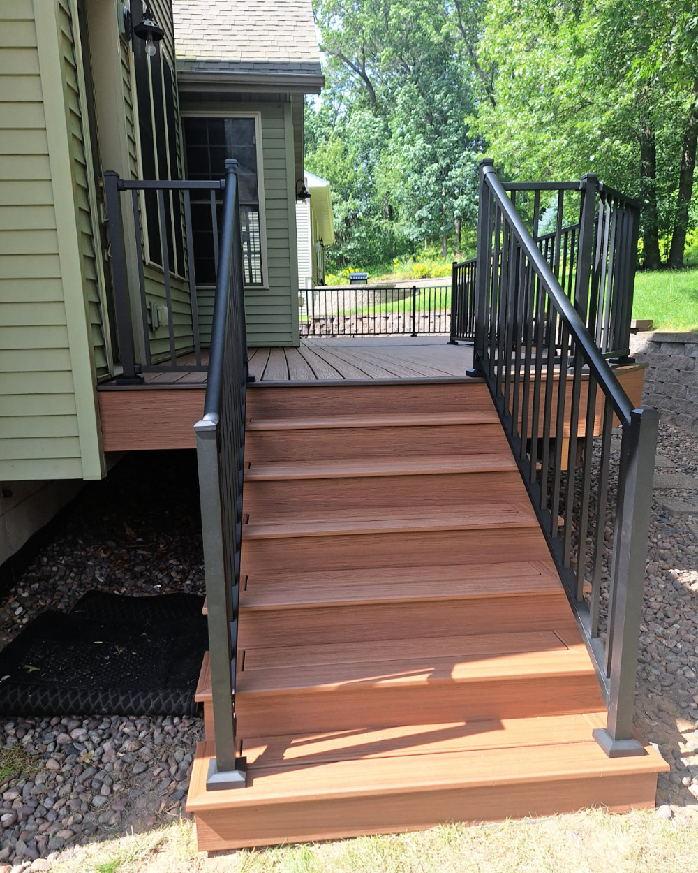 Rock Railing Composite deck stairwell build with metal railing in Eau Claire ...